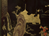 zbliżenie na dekorację płycin parawanu - pejzaże chińskie w ramie wypełnionej ornamentem plecionkowym