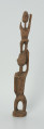 drewniana, rzeźbiona figura - Ujęcie z tyłu. Drewniana, rzeźbiona figura przedstawiająca postać człowieka niosącego na plecach drugą osobę.