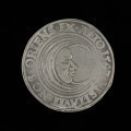 talar - Ujęcie rewersu. Na rewersie monety pólksiężyc z ludzką twarzą w prawo i napis w otoku.