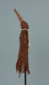 maska - Ujęcie z prawego boku. Maska wykonana z łyka drzewa, do której przymocowany jest bawełniany sznurek.