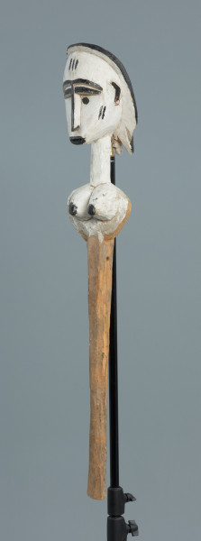lalka teatralna: Mèrè - Ujęcie z przodu skosem w lewą stronę. Marionetka przedstawiająca popiersie kobiece o jasnej, białej karnacji. Podłużna głowa okolona włosami z włóczki o wyraźnie zaznaczonych brwiach.