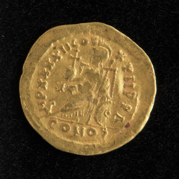 moneta; Złoty solid cesarza Teodozjusza II - Ujęcie rewersu. Złoty solid cesarza Teodozjusza II. Powierzchnie są nieco starte, ale treść awersu i rewersu jest czytelna.