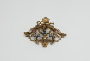 biżuteria, ozdoby - Ujęcie w pionie przodu klejnotu. Ażurowy klejnot z kołpaka z diamentem i - pierwotnie -czterema perłami, zdobiony barwną emalią.