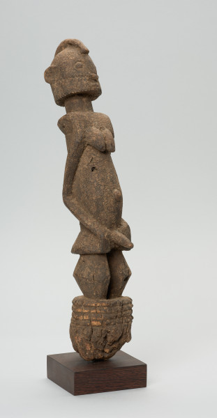 rzeźba - Ujęcie z przodu z prawej strony. Figura przedstawiająca postać przodka łączącego w sobie cechy obu płci. Wyraźnie zaznaczone są piersi kobiece oraz penis - co rzadko spotyka się w sztuce dogońskiej.