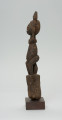 rzeźba - Ujęcie lewego boku. Figura - postać przodka. Figura przedstawia postać kobieta z uniesionymi do góry rękoma.