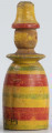 E/216/ML - Gwizdek wytoczony z drewna w kształcie głowy i tułowia lalki. Malowany barwami: żółtą, czerwoną i zieloną. Służy jako zabawka.