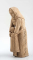 Rzeźba w drewnie lipowym, niepolichromowana, przedstawiająca postać kobiety nachylonej nad dzieckiem, stojącym przy kolanach. Kobieta w chustce na głowie zawiązanej pod brodą, o twarzy trójkątnej, dużych oczach, wąskich ustach. Ubrana w bluzkę z długimi rękawami i serdak z zaznaczoną baskinką , w długiej spódnicy pokrytej stylizowanymi wielopłatkowymi kwiatami na gałązce. U dołu biegnie pasek w formie falistej linii. Kobieta obejmuje rękami dziecko, zwrócone do niej twarzą. Dziecko z włosami sięgającymi do szyi, zaznaczonymi rowkowanymi nacięciami – uczesane z przedziałkiem  pośrodku. W długiej sukience, ozdobionej falistymi liniami poziomymi u dołu i góry, pionowymi pośrodku. 