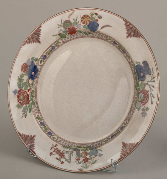 Talerz płytki, zdobiony motywem roślinnym, kwiatowym i geometrycznym w kolorze zielonym, czerwonym, niebieskim i złotym