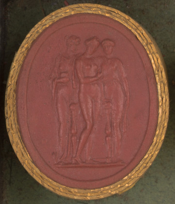 czerwona owalna gemma w grubym złotym obramowaniu; trzy młode kobiety, kobieta po środku naga, po prawej i lewej stronie kobiety ubrane w lekkie, prześwitujące szaty; na dole sygnatura lliXAEP ( PICHLER)