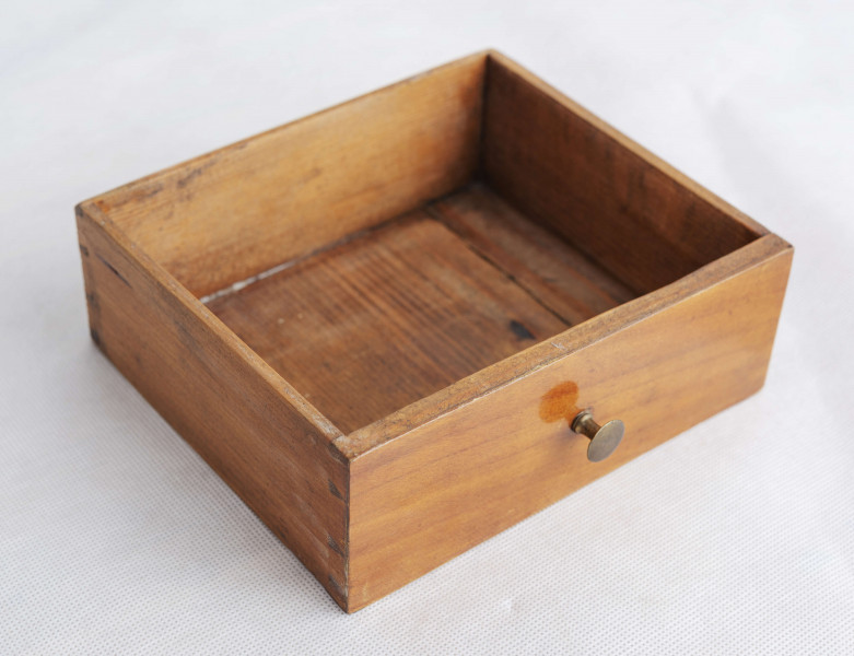 Biurko przyścienne na sześciu nóżkach graniastych zbieżnych. W części dolnej prostokątny prześwit zamknięty tylną ścianą. Po jego bokach po dwie szuflady, powyżej jeszcze trzy. Część górna ćwierćcylindryczna zamykana żaluzją chowaną pod górna płytą powyżej pięciu szufladek, boki zdobione plastycznym ornamentem cekinowym. Lico pokryte fornirem z intarsją ramkową i wzorem arkadkowym. Blat wyłożony skórą cielęcą. Uchwyty szuflad zewnętrznych i żaluzji to nałożone okucia okrągłe z tarczą, szufladki w części górnej mają uchwyty okrągłe z gładką główką.  