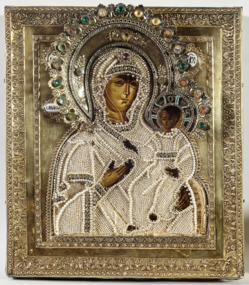 ikona z wizerunkiem Bogurodzicy Hodigitrii Smoleńskiej w półpostaci; Dzieciątko siedzi po prawej stronie, prawicą błogosławi, w lewicy trzyma zwinięty zwój; w krzyżowym nimbie Chrystusa monogram ωTOH; w tle inskrypcje cyrylickie opisujące postacie: IC XC;  МР ΘУ |  ОДИГІТРИЯ; na lico nałożony okład i aplikacja